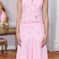 A pink sleeveless halter dress with a V-neckline, decorated with sequins and embroidered floral details on the bodice, paired with a matching flared skirt featuring small embroidered motifs, shown on a model in an indoor setting.