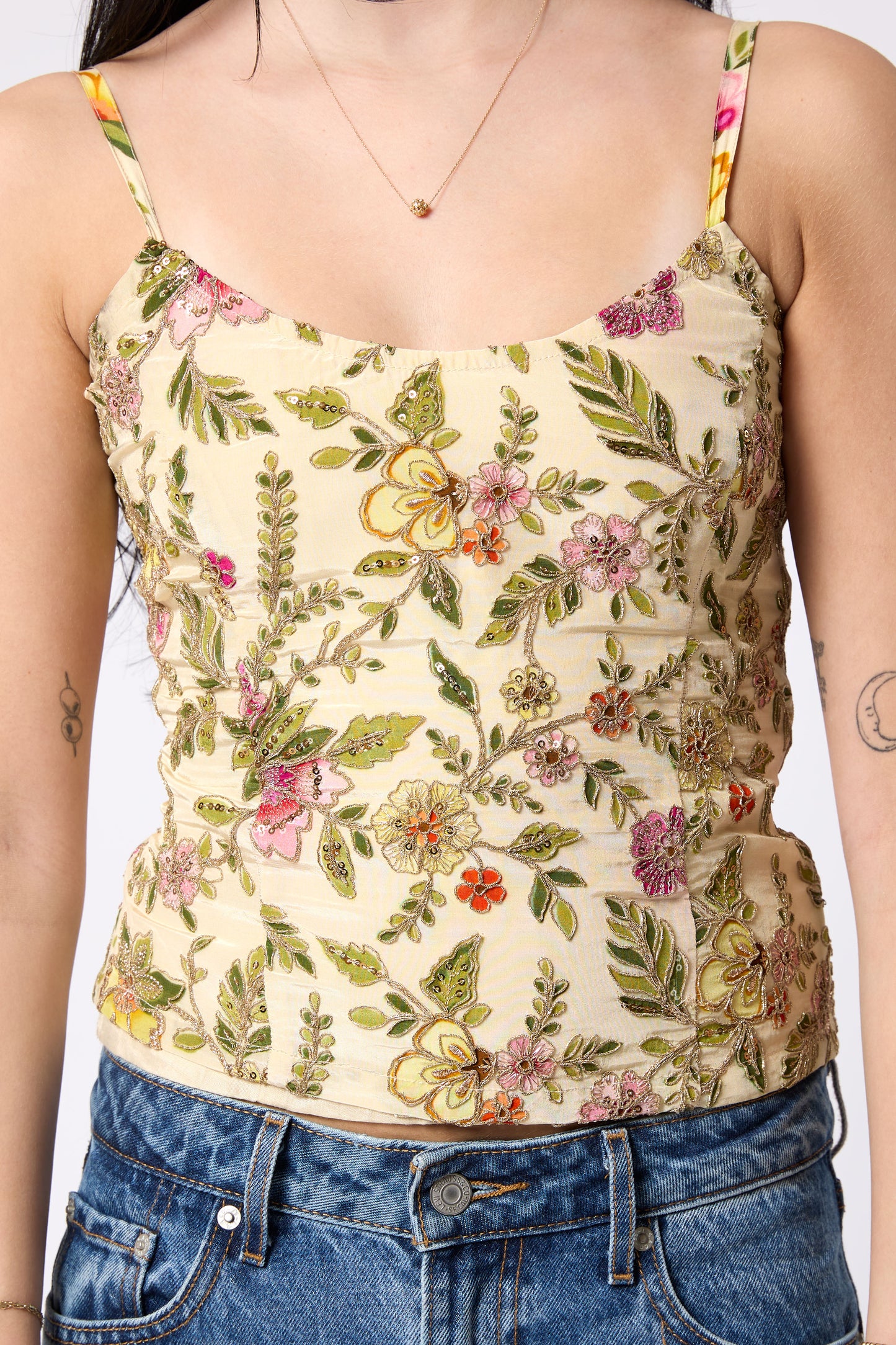 Floral patterned tank top worn by a person with a neutral background