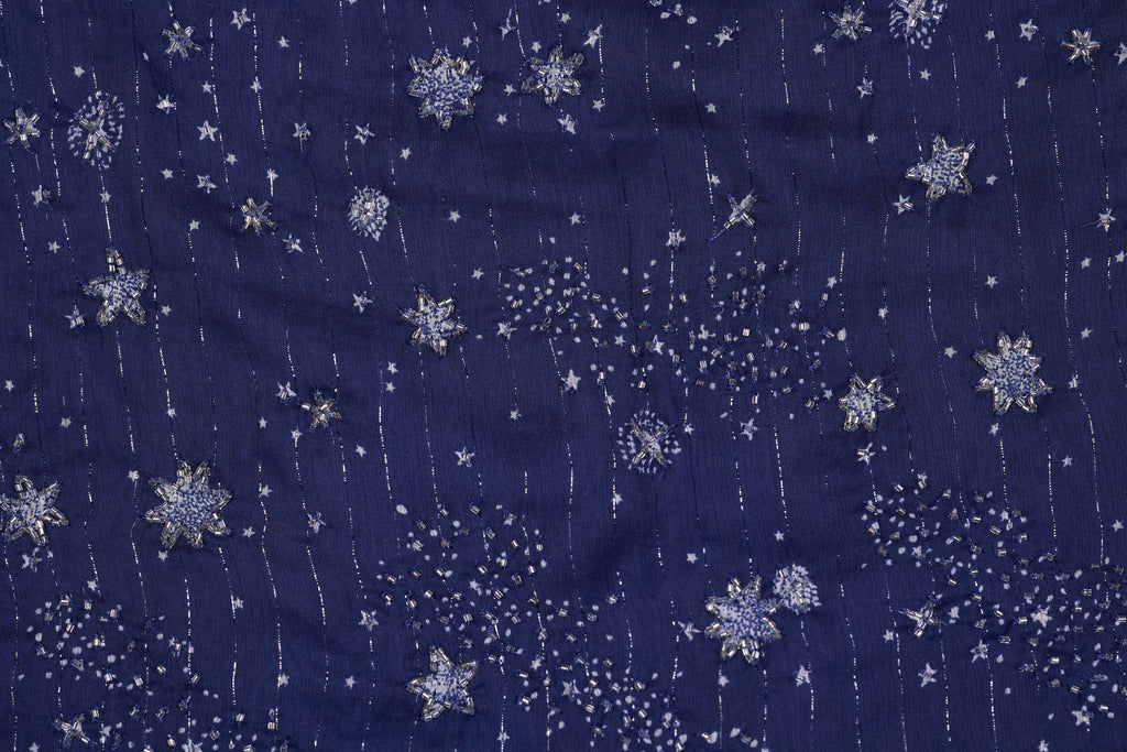 Navy blue fabric with silver snowflake pattern