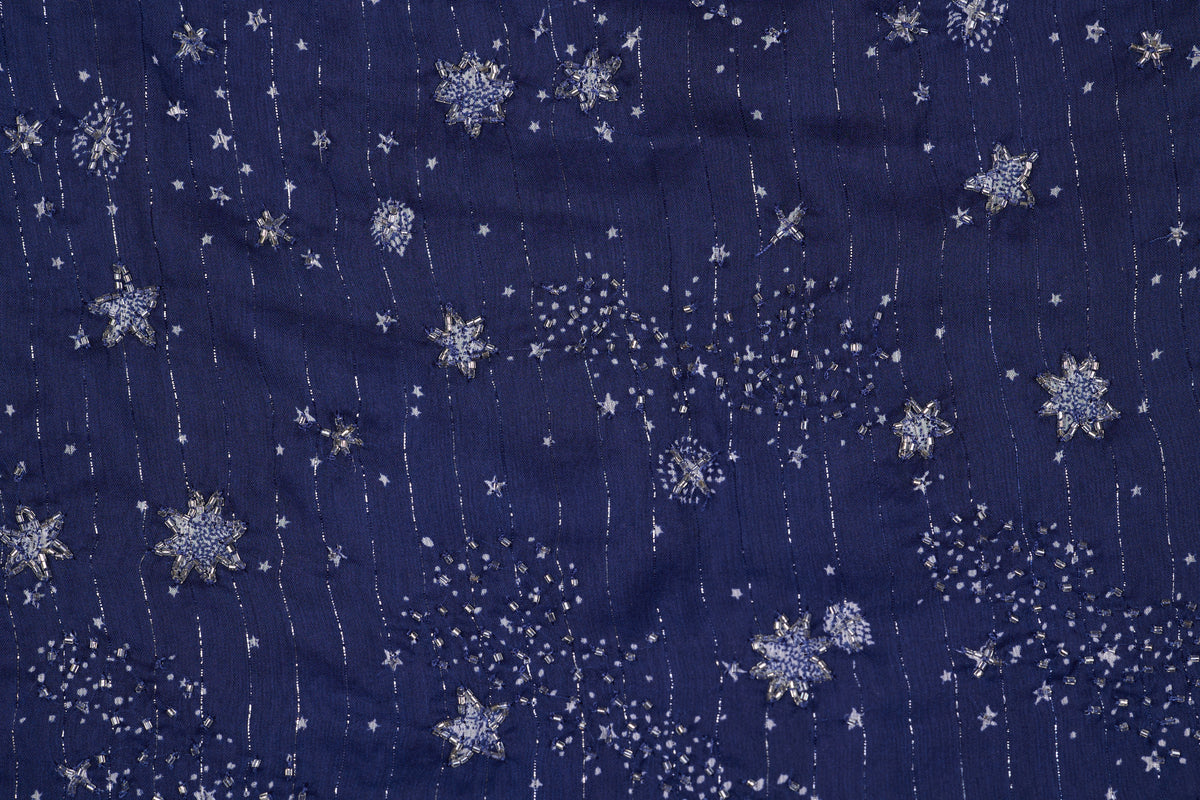 Navy blue fabric with silver snowflake pattern