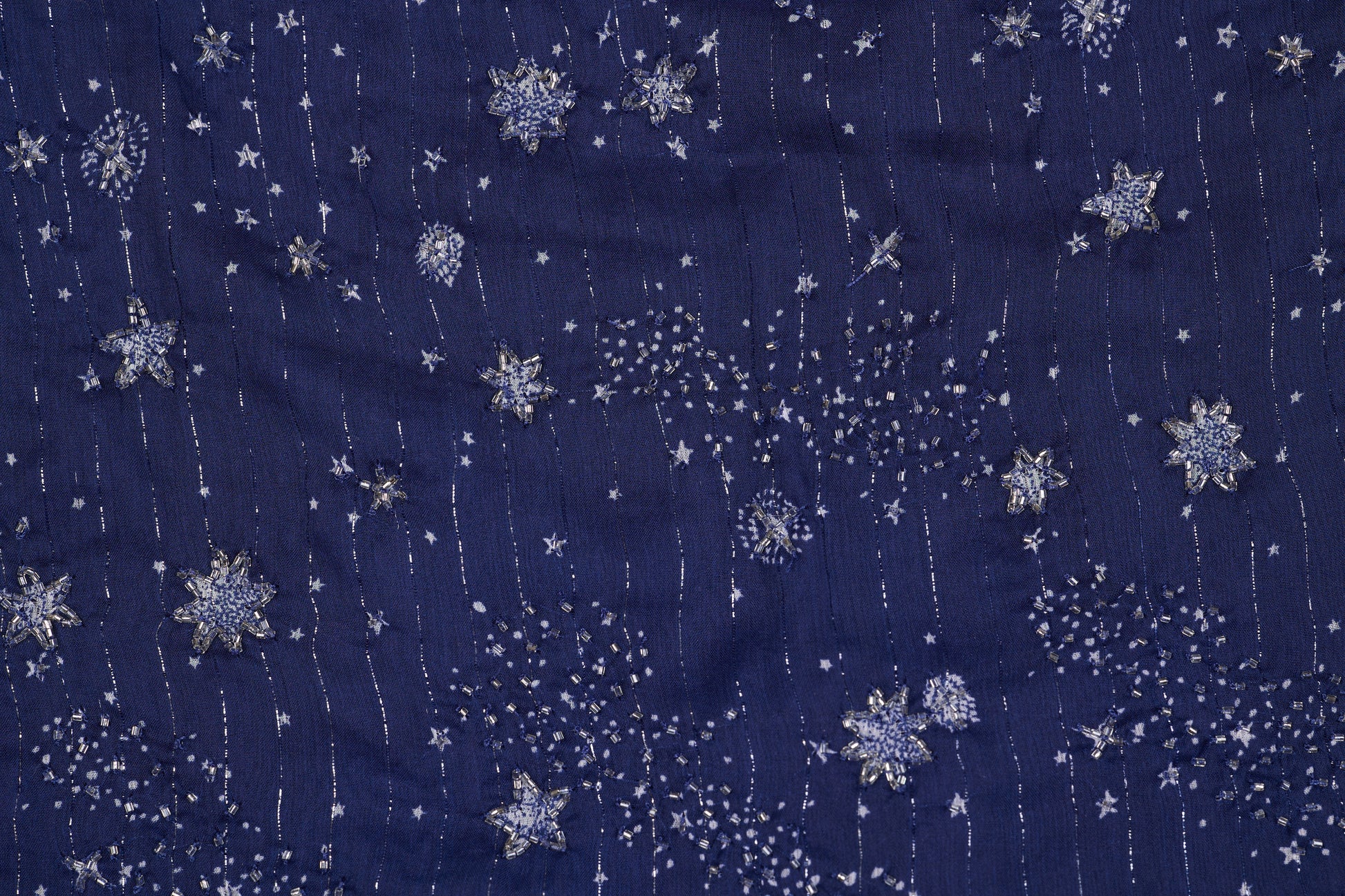 Navy blue fabric with silver snowflake pattern